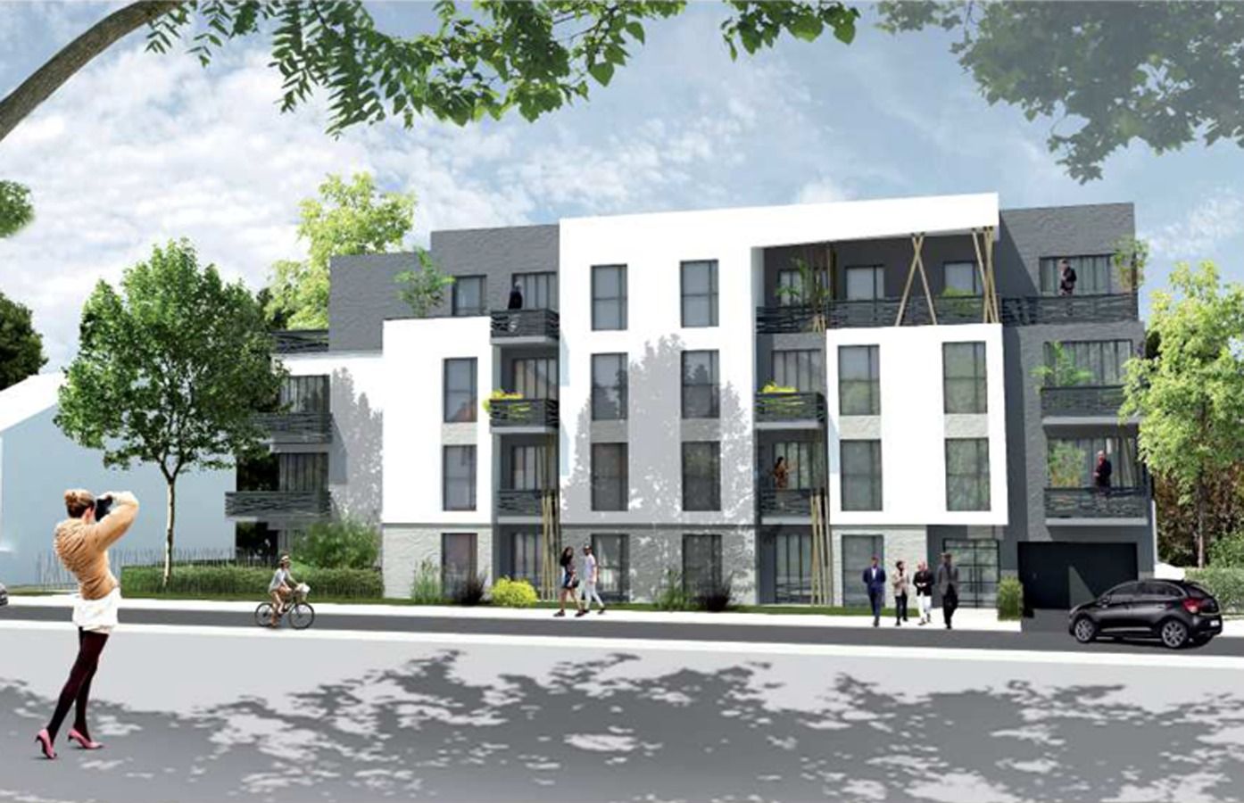 Immeuble de logements blanc et gris avec balcons, vu depuis une rue arborée